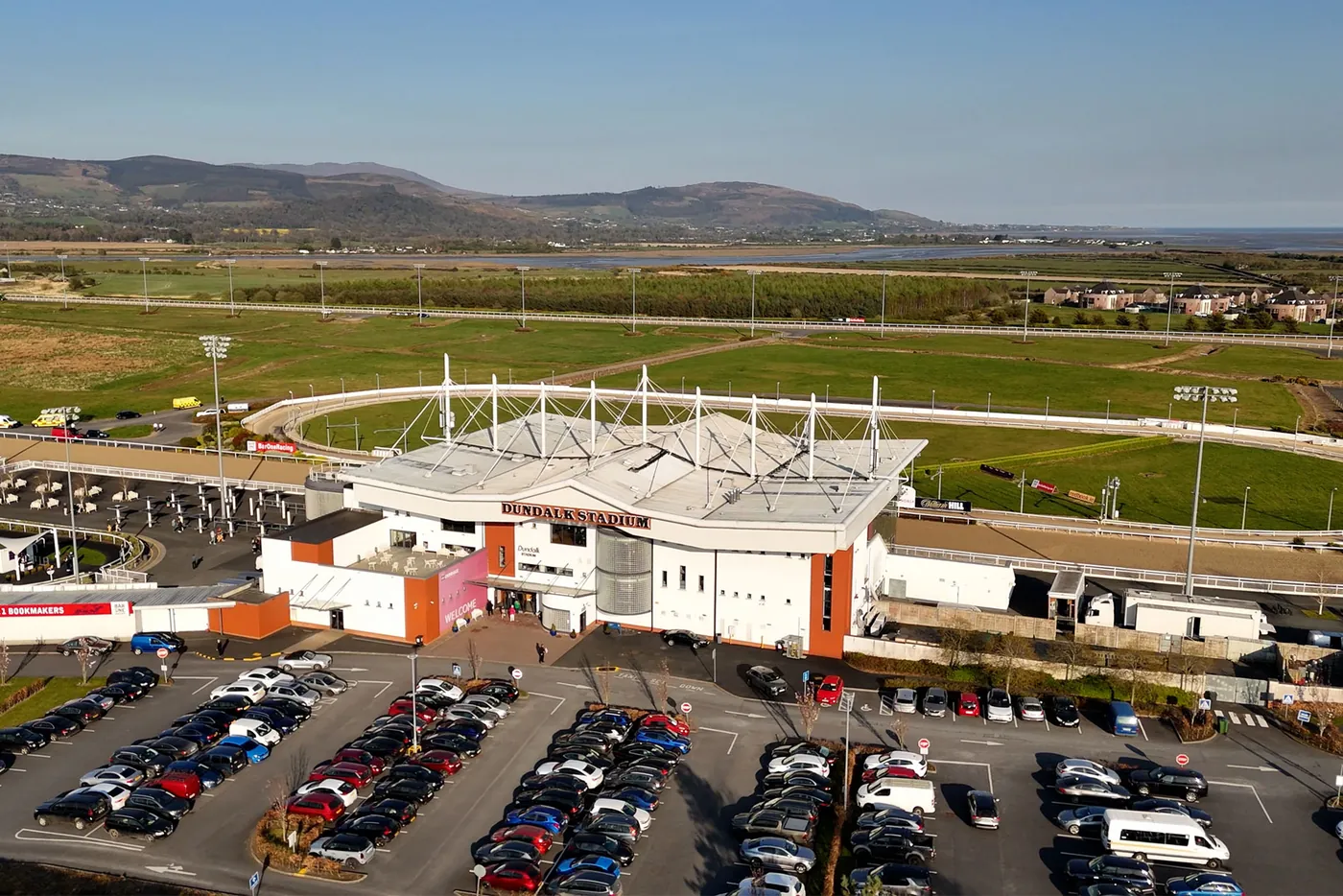 The grandstand and the free car park, with the horse track and Cooley Mountains behind